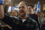 Ian Harvie raising a beer and cheering in a 2016 Bud Light ad about gender