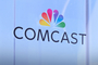 Comcast logo signage on a glass wall
